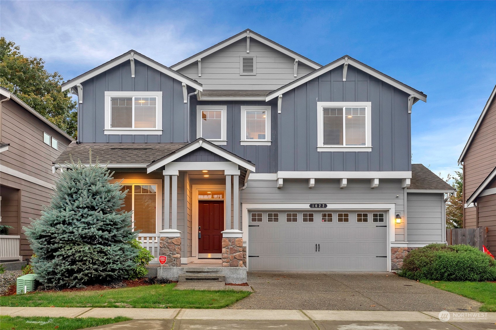 a front view of a house with a yard and garage