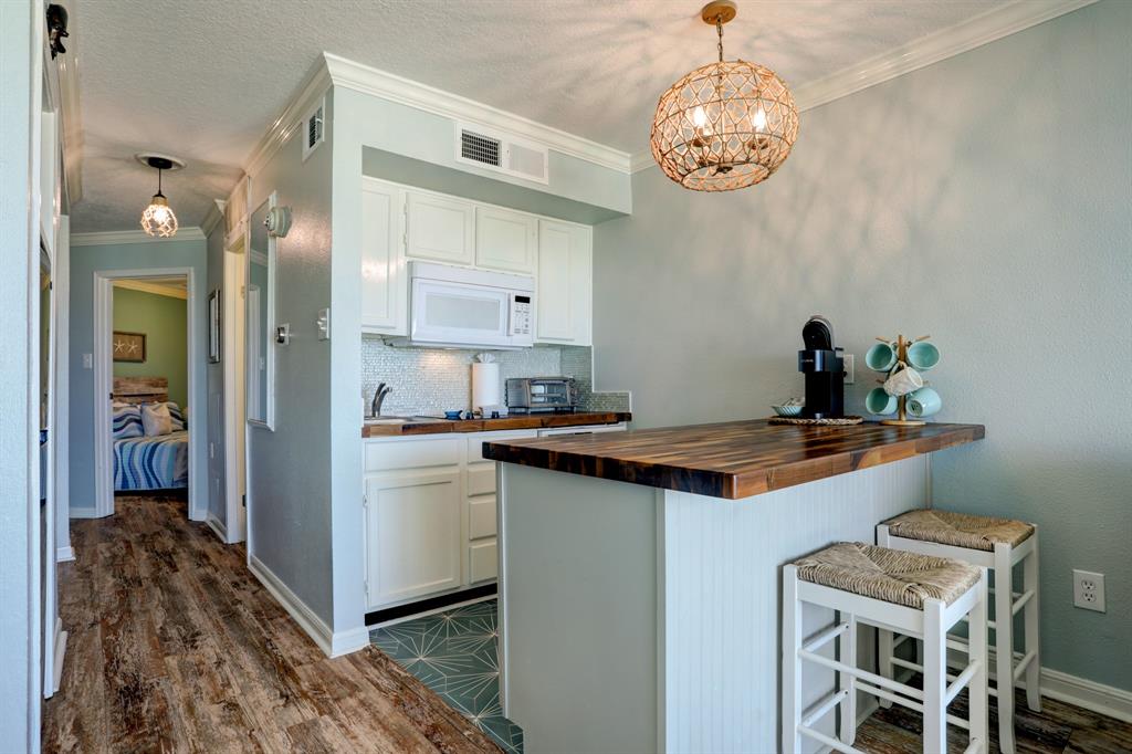 a kitchen with stainless steel appliances granite countertop a sink and a refrigerator