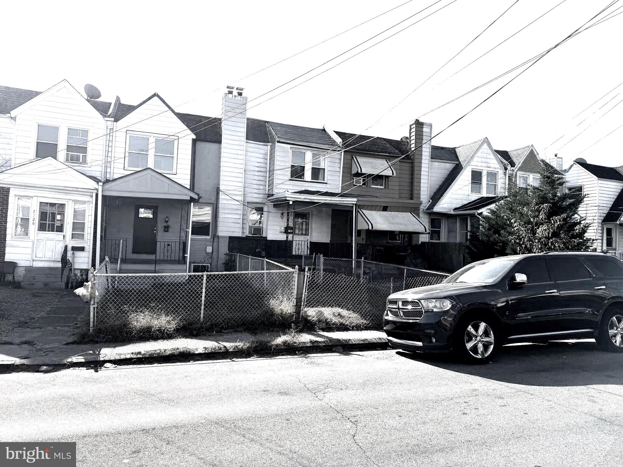 a view of a car parked in front of a house