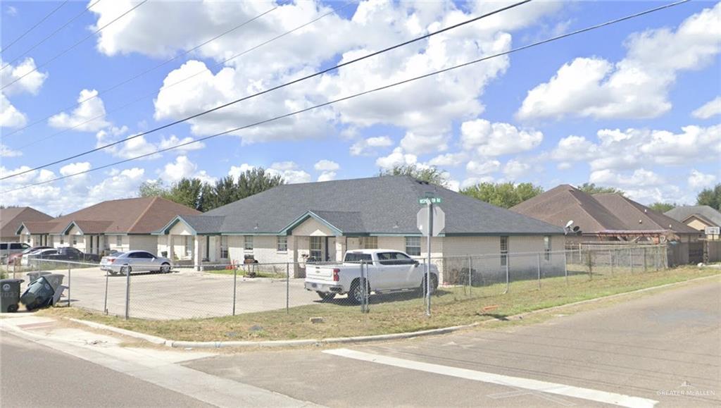 a view of a house with a patio and a yard