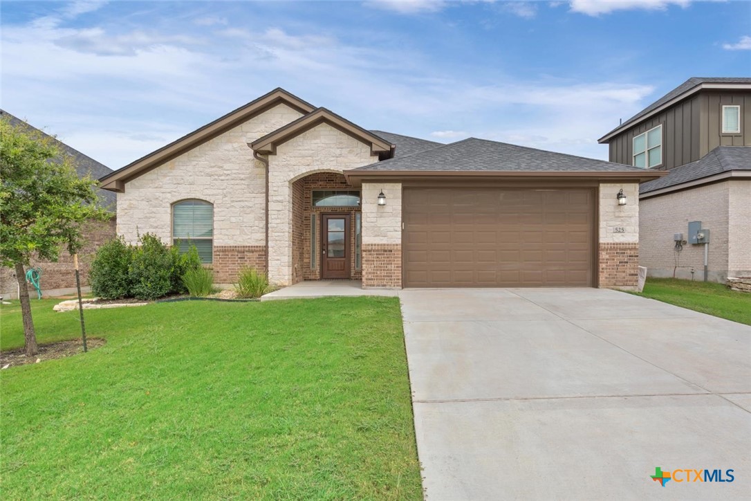 a front view of a house with a yard and garage