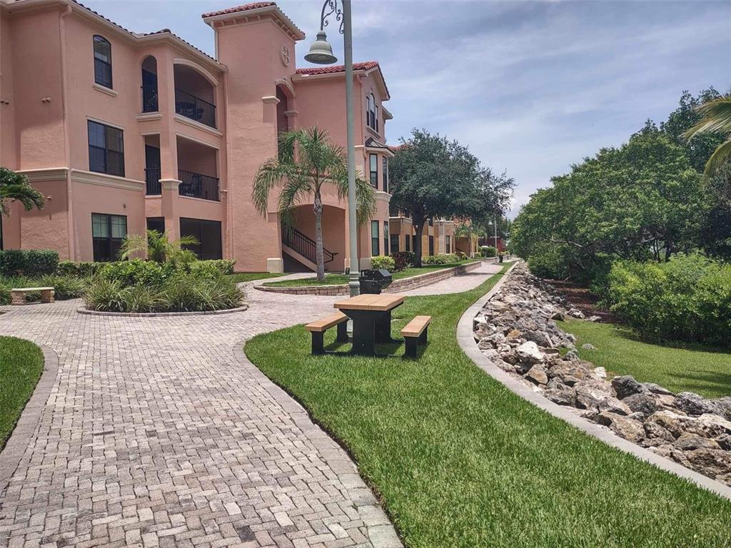 a swimming pool with barbeque oven outdoor seating and yard