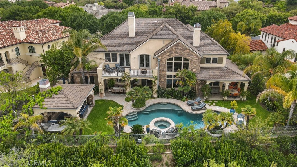 an aerial view of a house with swimming pool garden and patio