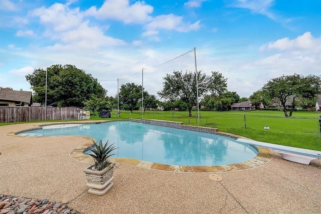 a view of a swimming pool and a yard