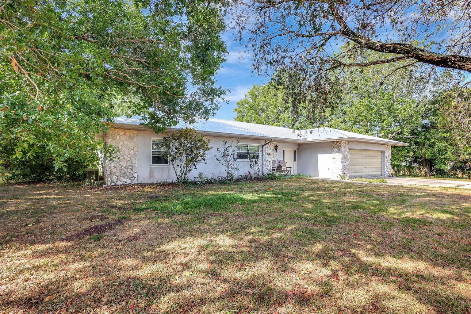 a view of a house with a yard and a garage