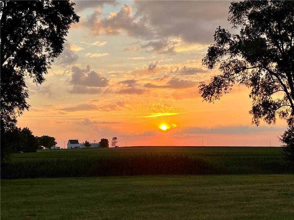 a view of sunset with green space