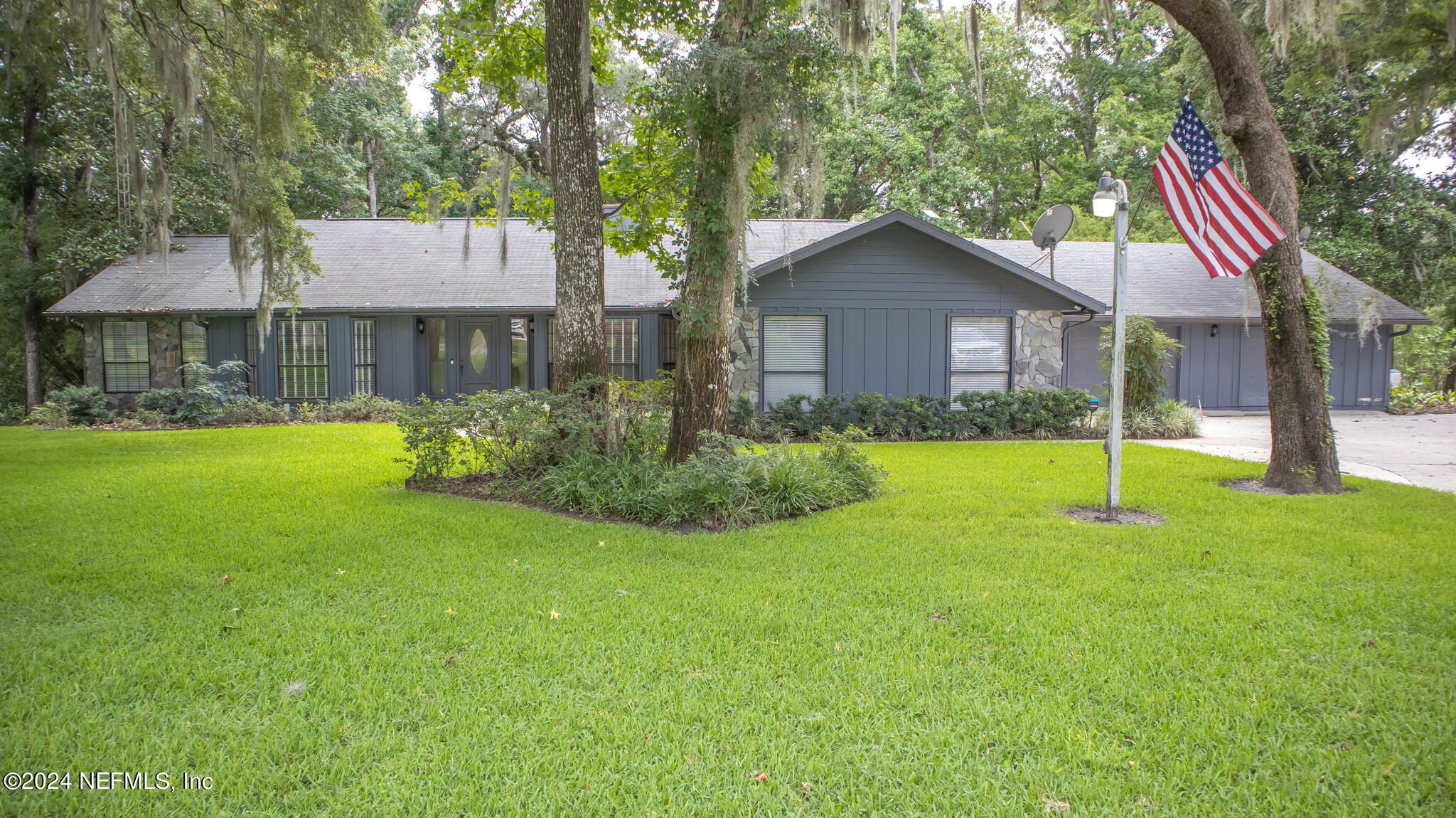 a view of a house with a yard and sitting area