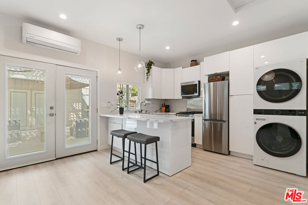 a kitchen with a refrigerator a microwave and cabinets