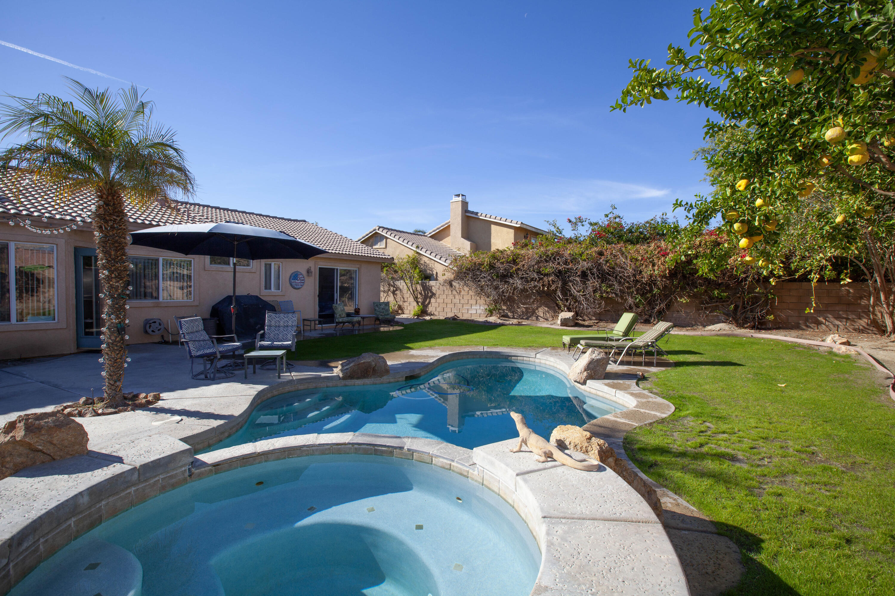 a view of a house with swimming pool and sitting area