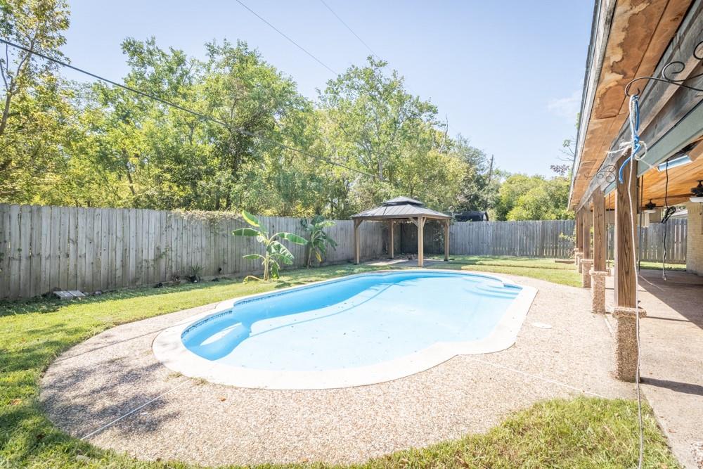 a view of a swimming pool with a patio