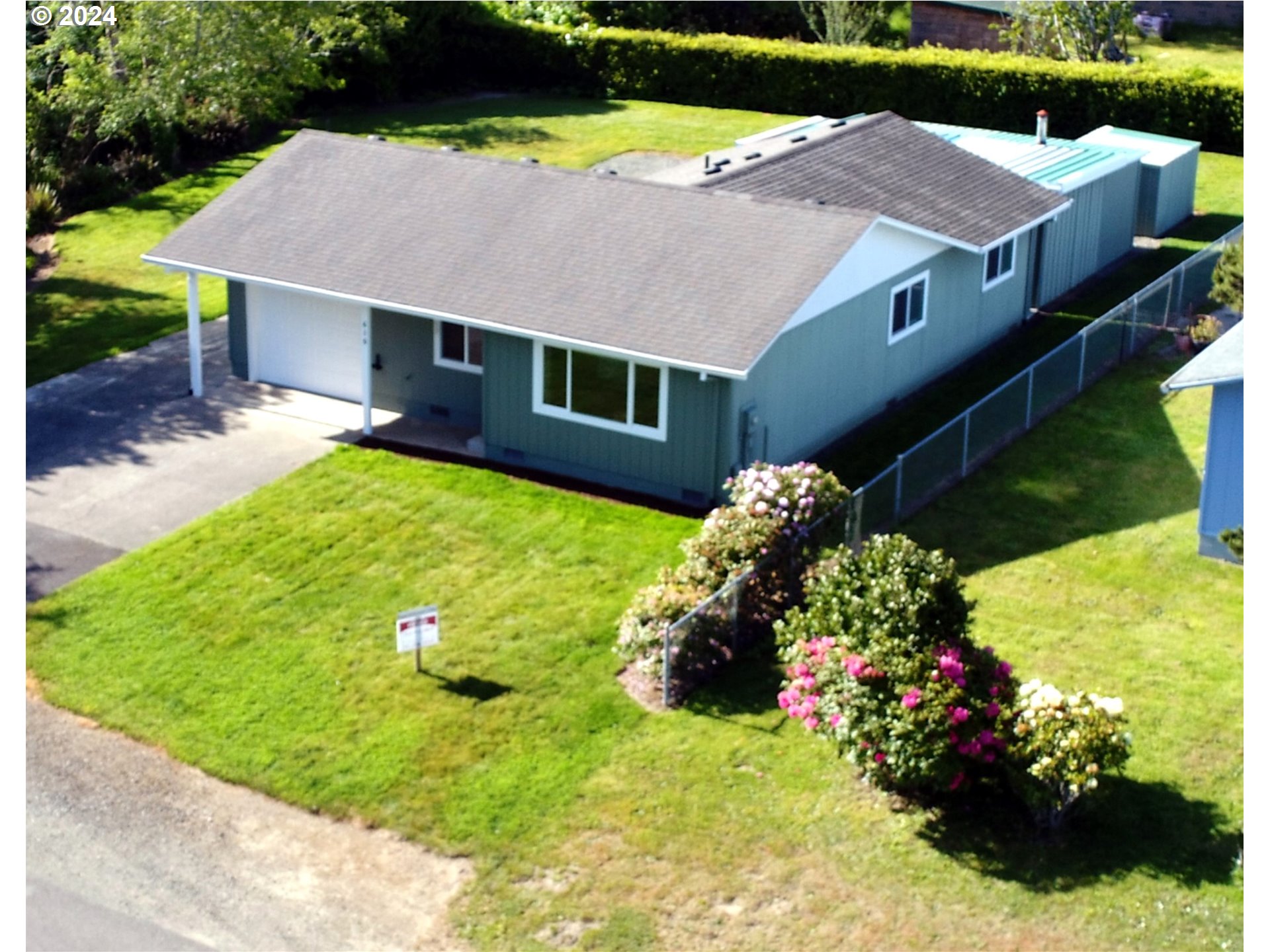 a aerial view of a house with a yard and a sitting area