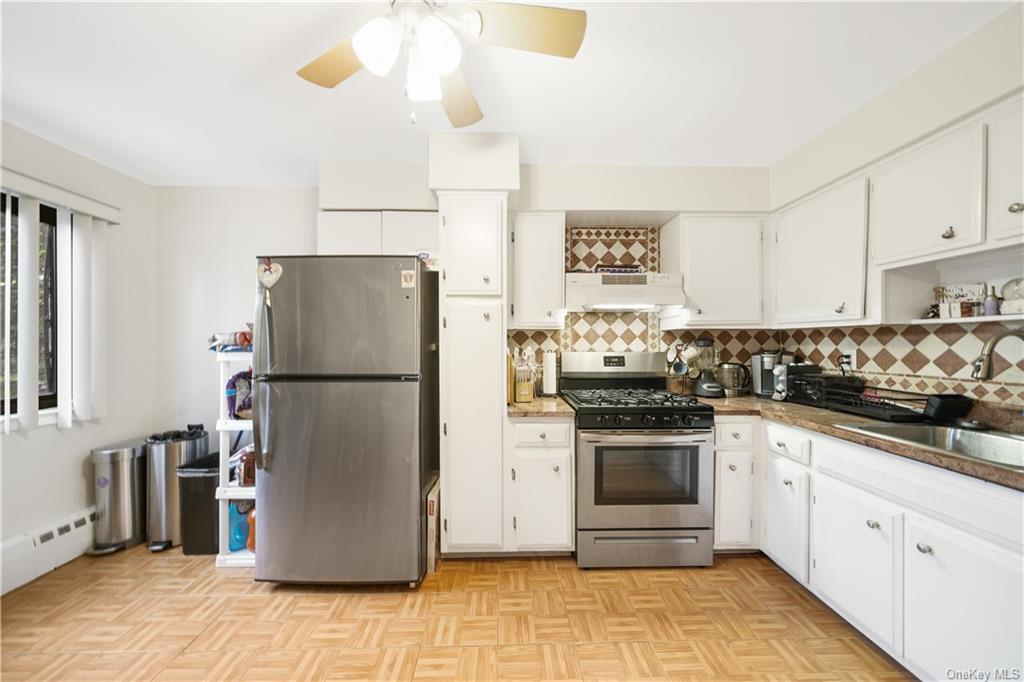 a kitchen with a refrigerator sink and cabinets