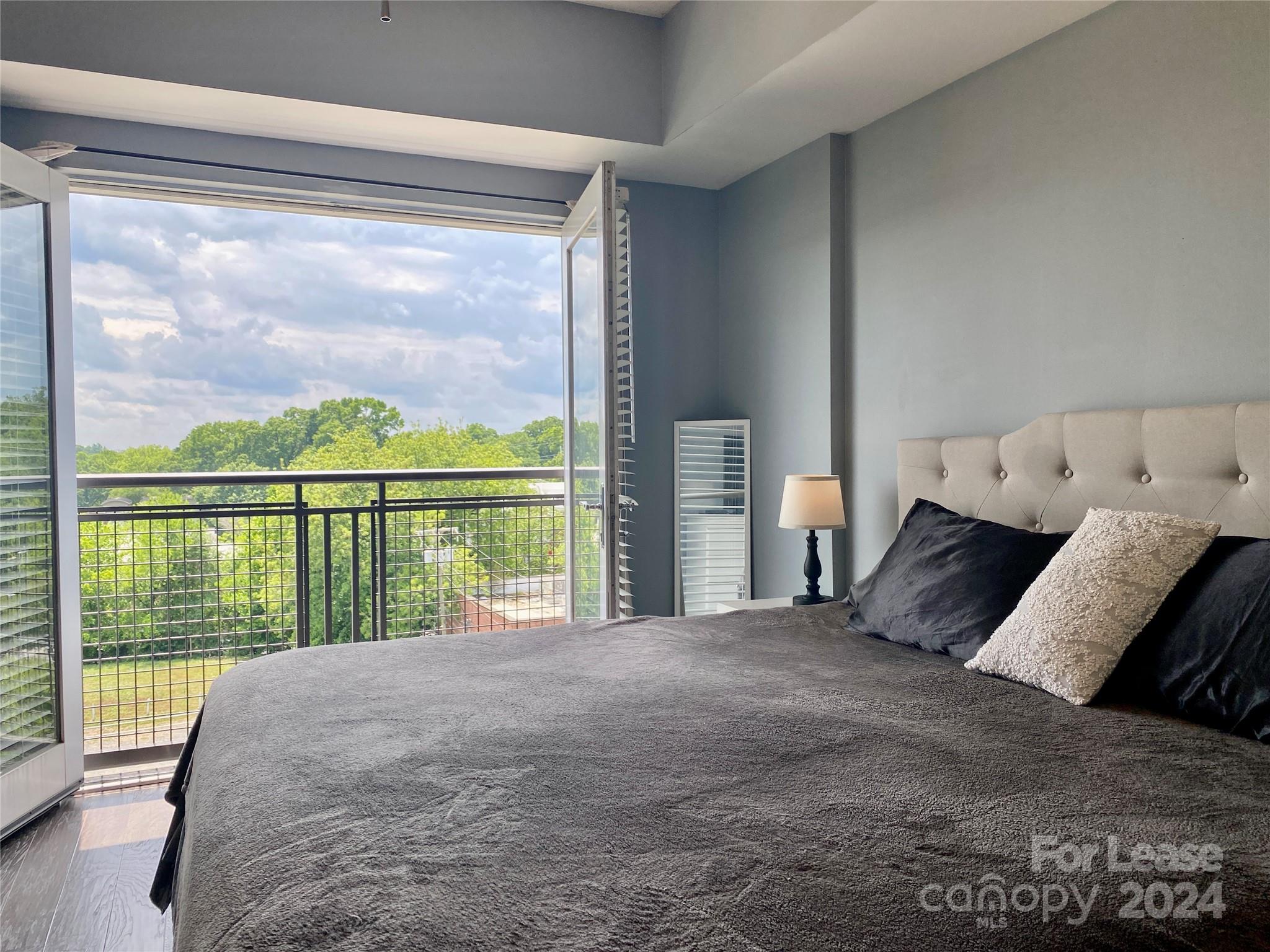 a bed sitting in a bedroom next to a large window