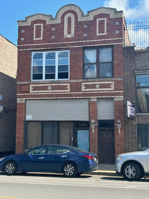 a view of a brick building with many windows