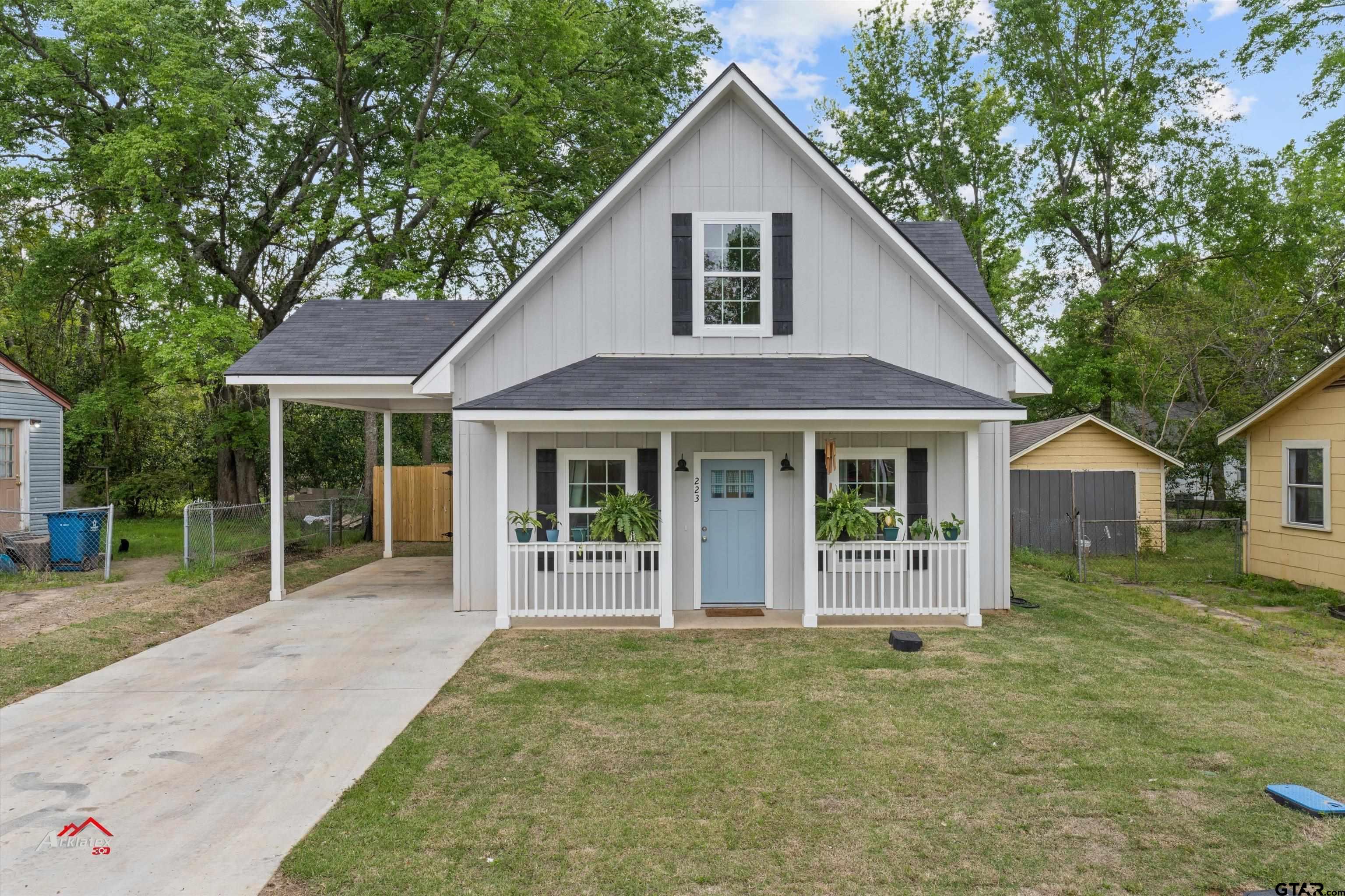 a front view of a house with a yard and porch