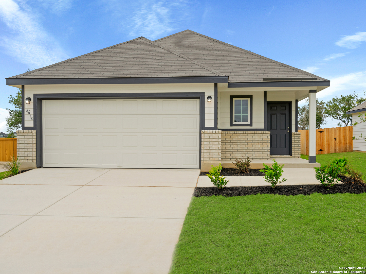 a front view of house with a garden