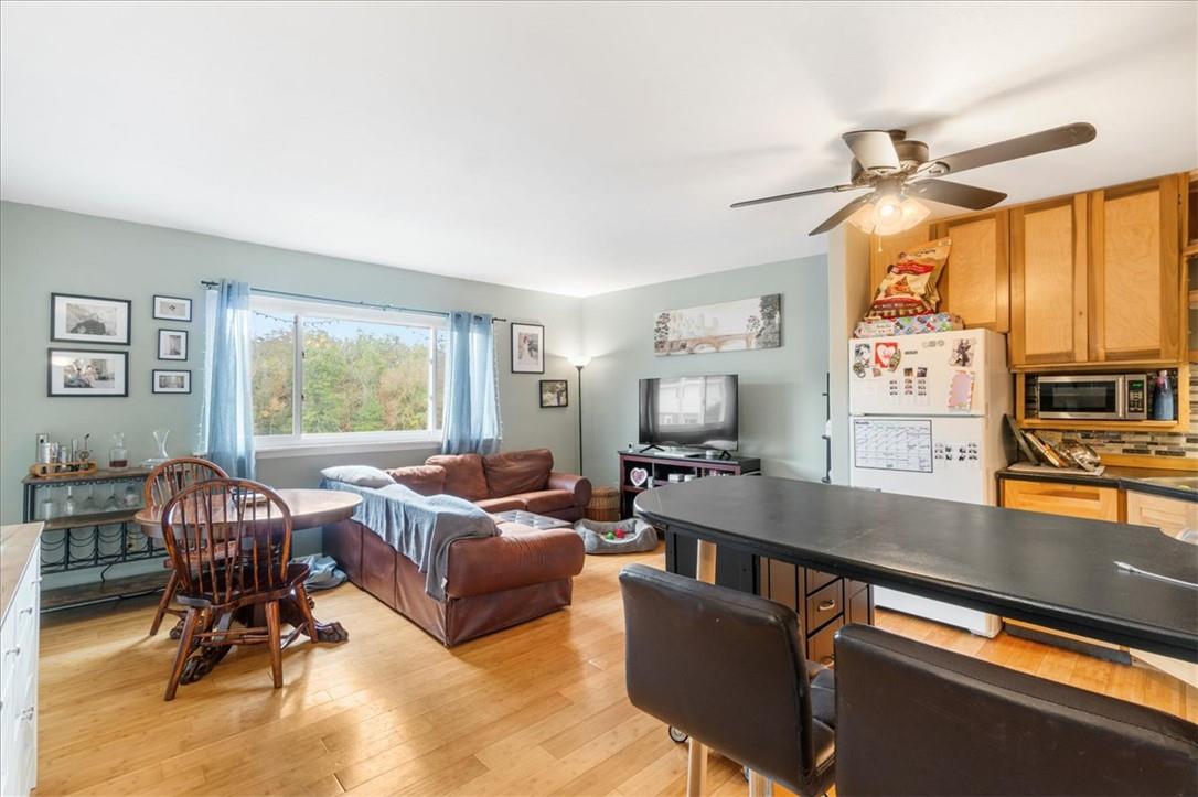 a living room with furniture a flat screen tv and a large window