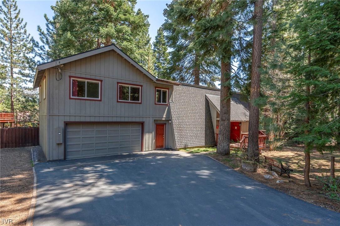 a view of a house with a yard and garage