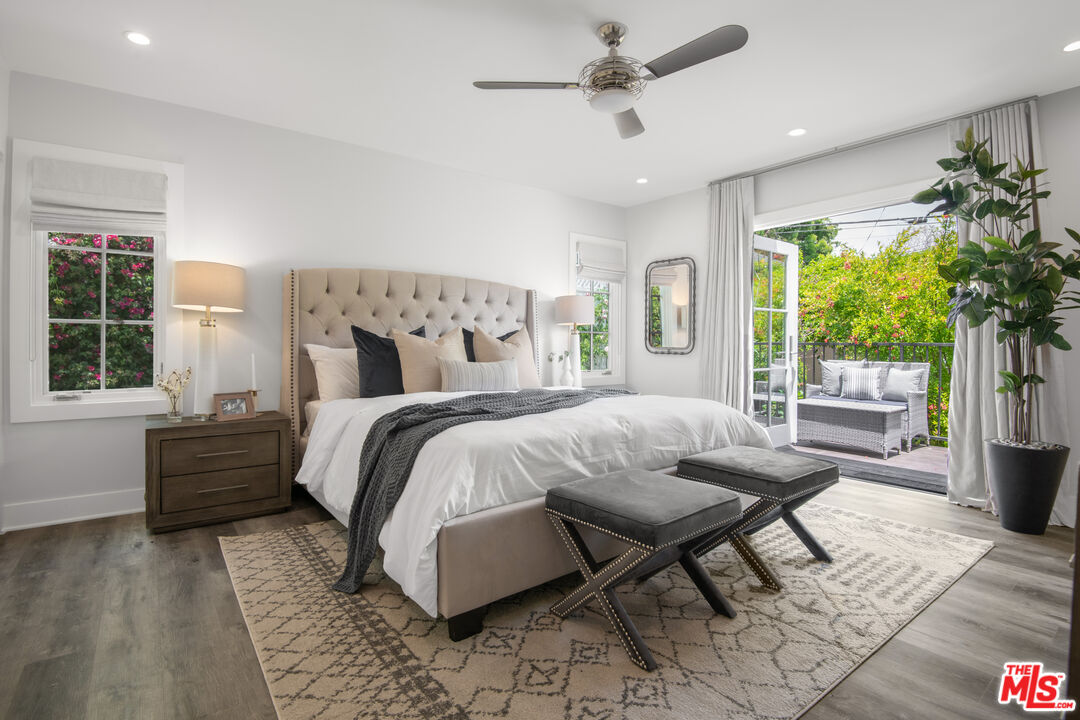 a bed sitting in a spacious bedroom next to a window