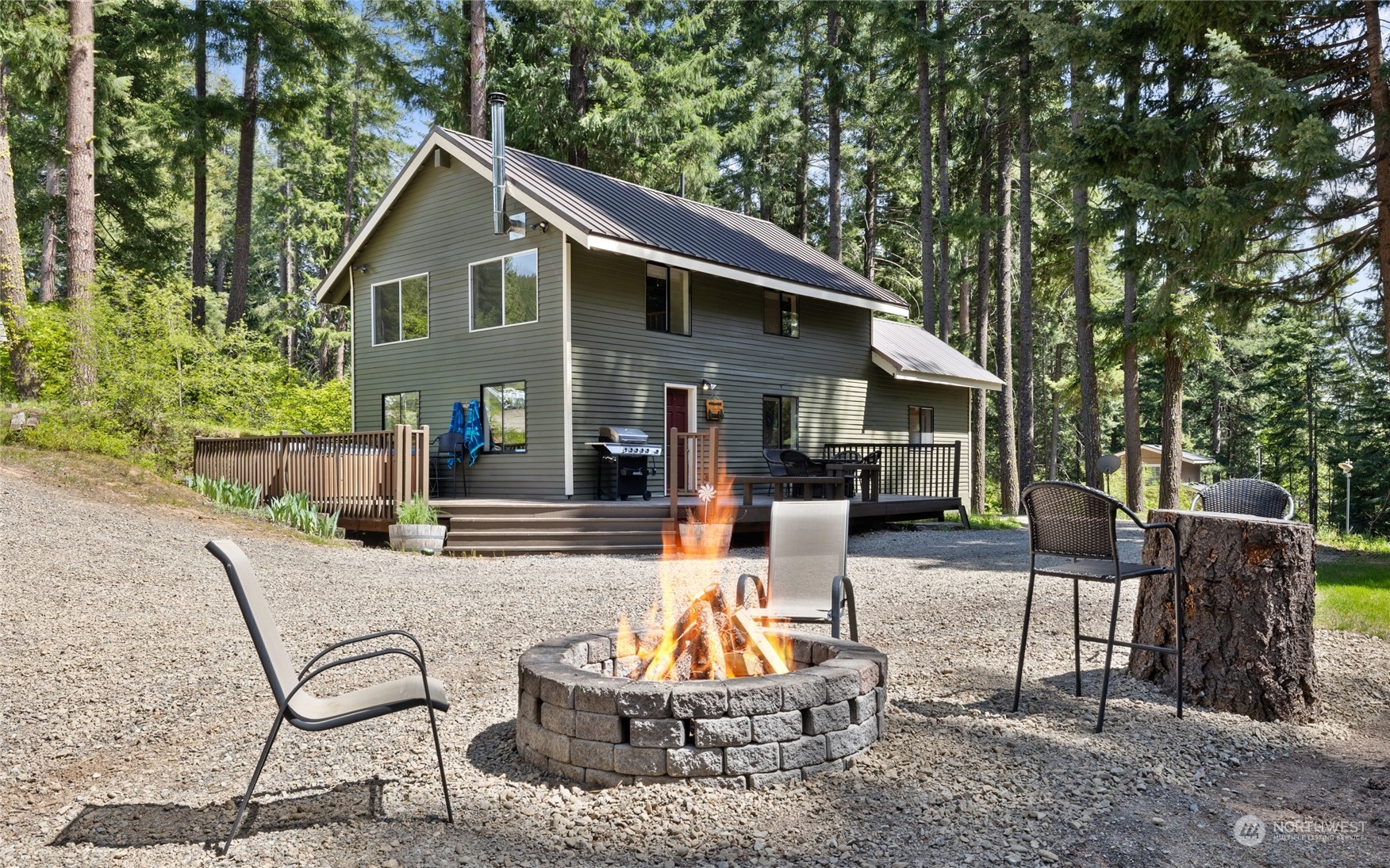 a view of a house with backyard and sitting area