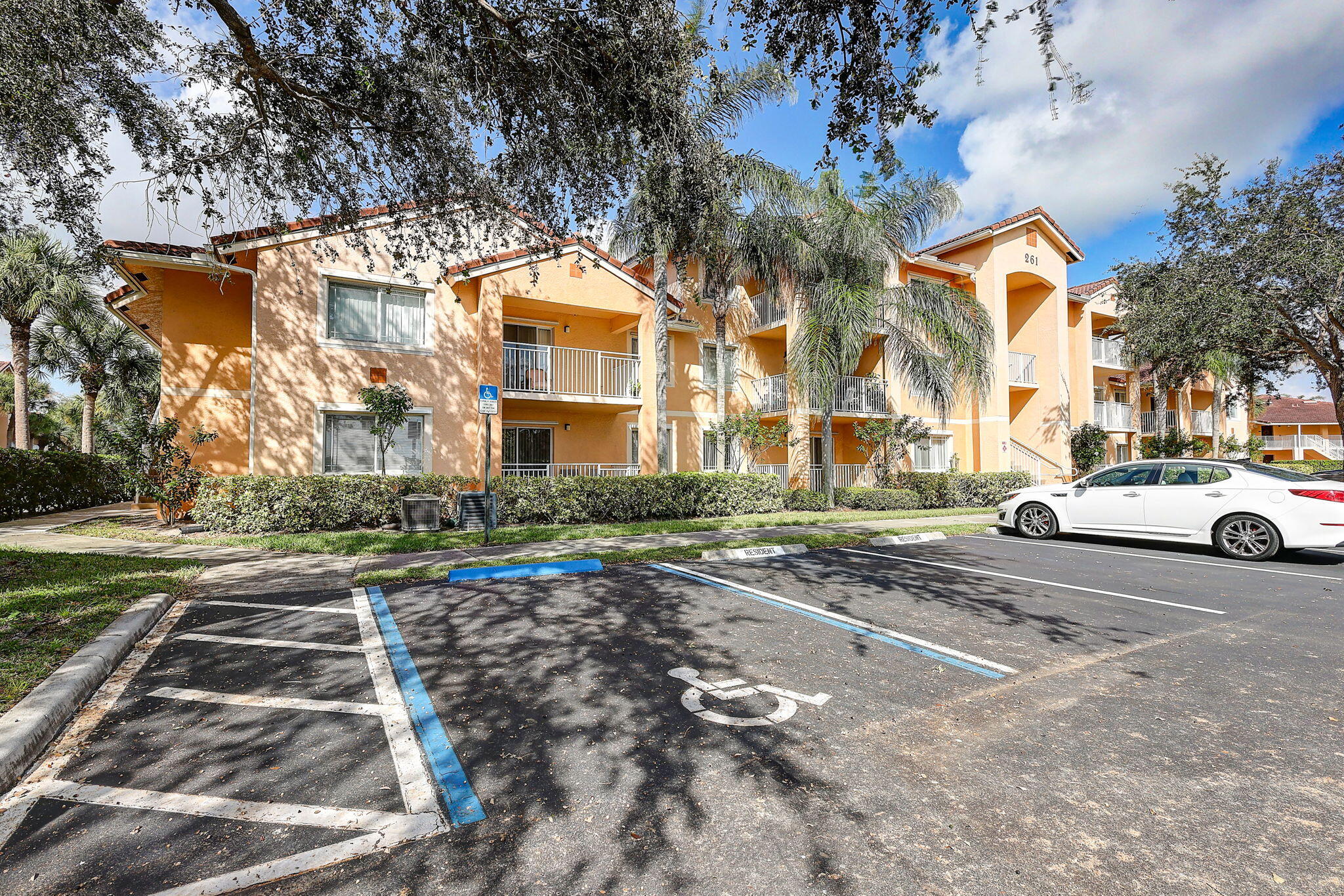 a front view of a residential apartment building with a yard