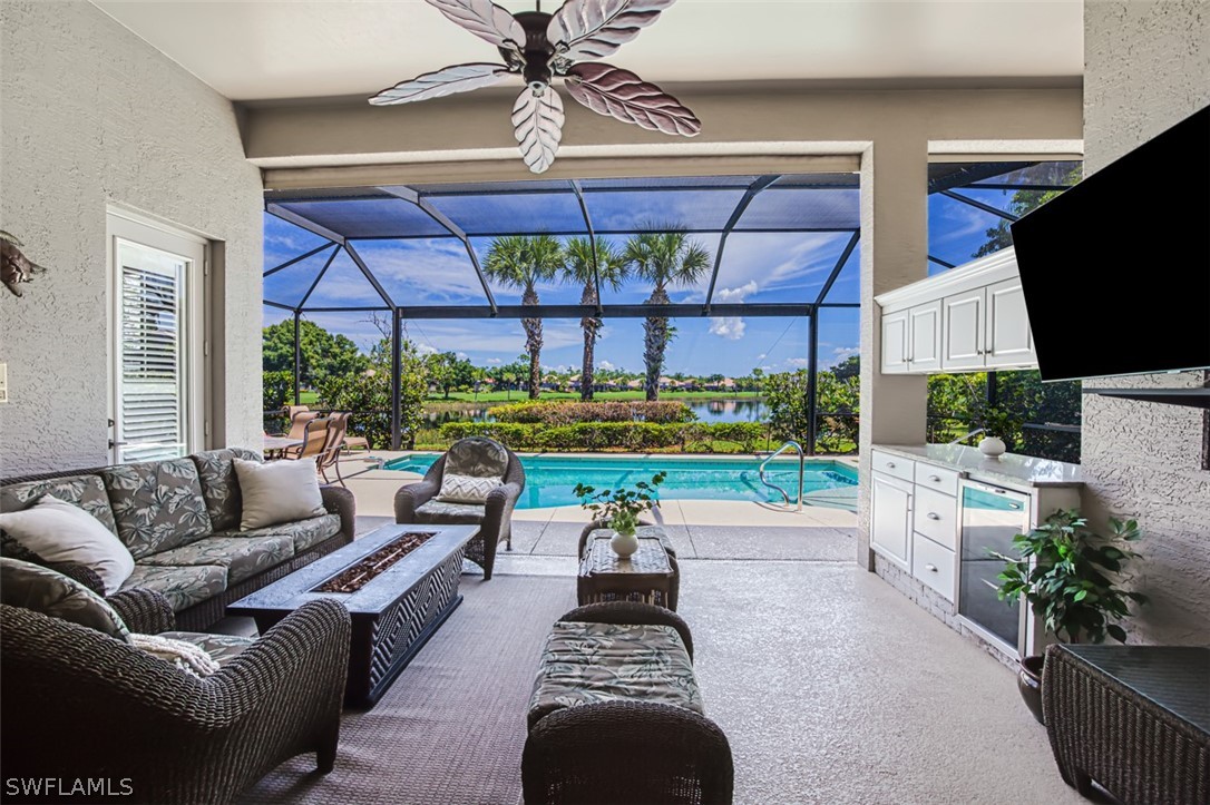 a living room with patio furniture and a floor to ceiling window