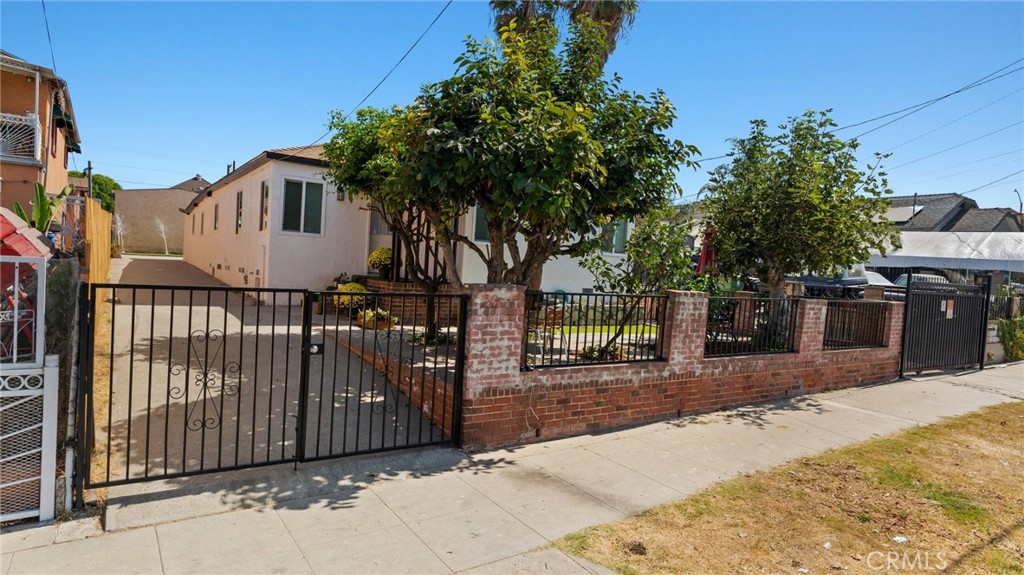 a view of a house with wooden fence