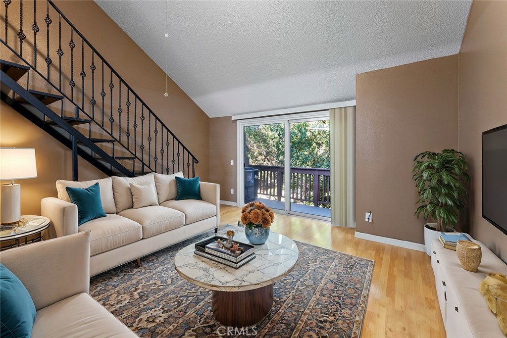 a living room with furniture rug and a window