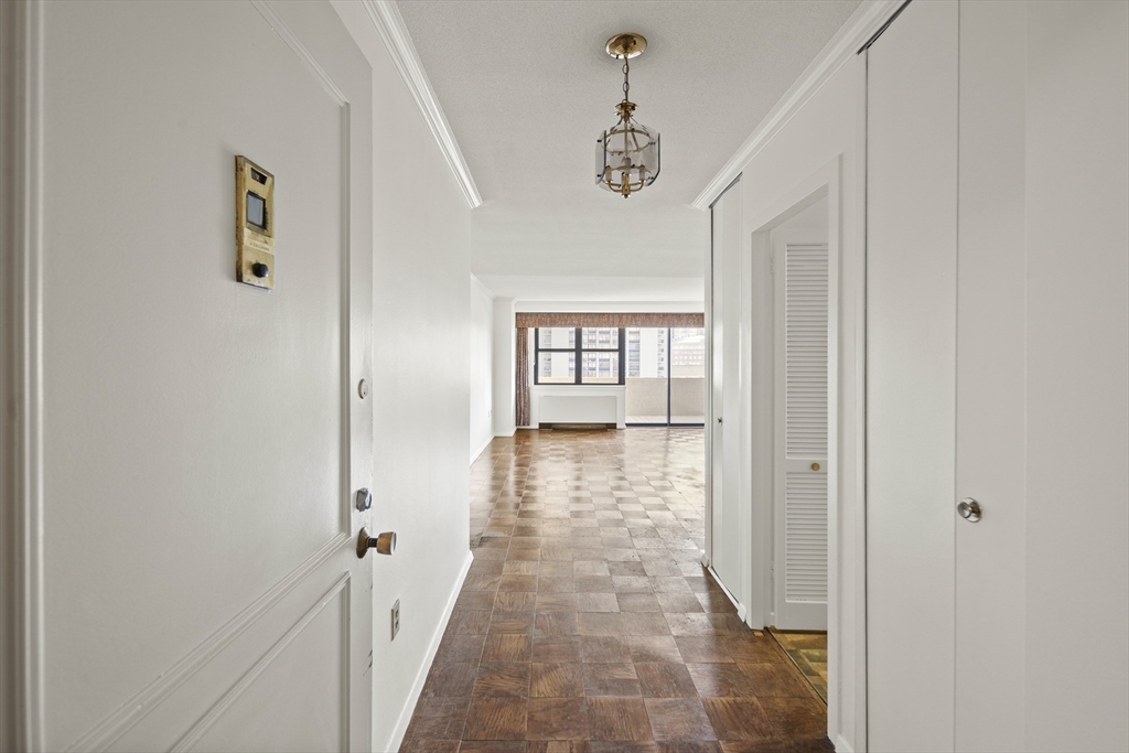 a view of a hallway with windows and stairs