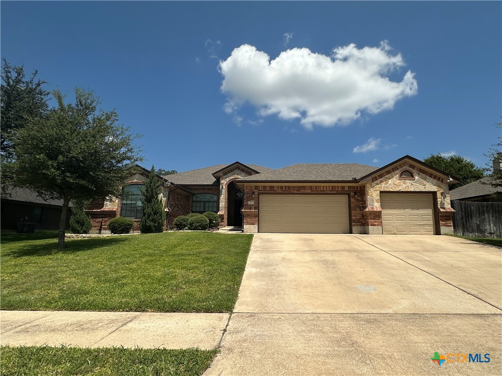 a front view of a house with a yard and garage