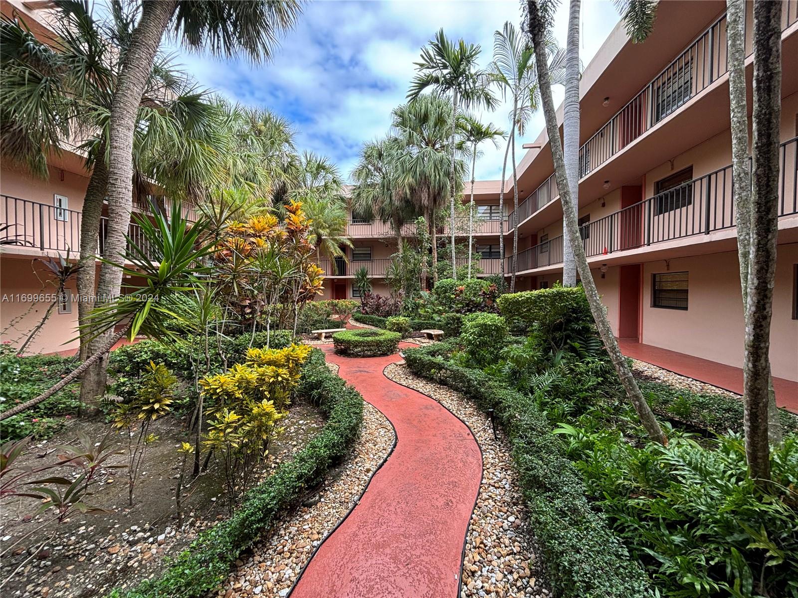 a view of a garden with a house