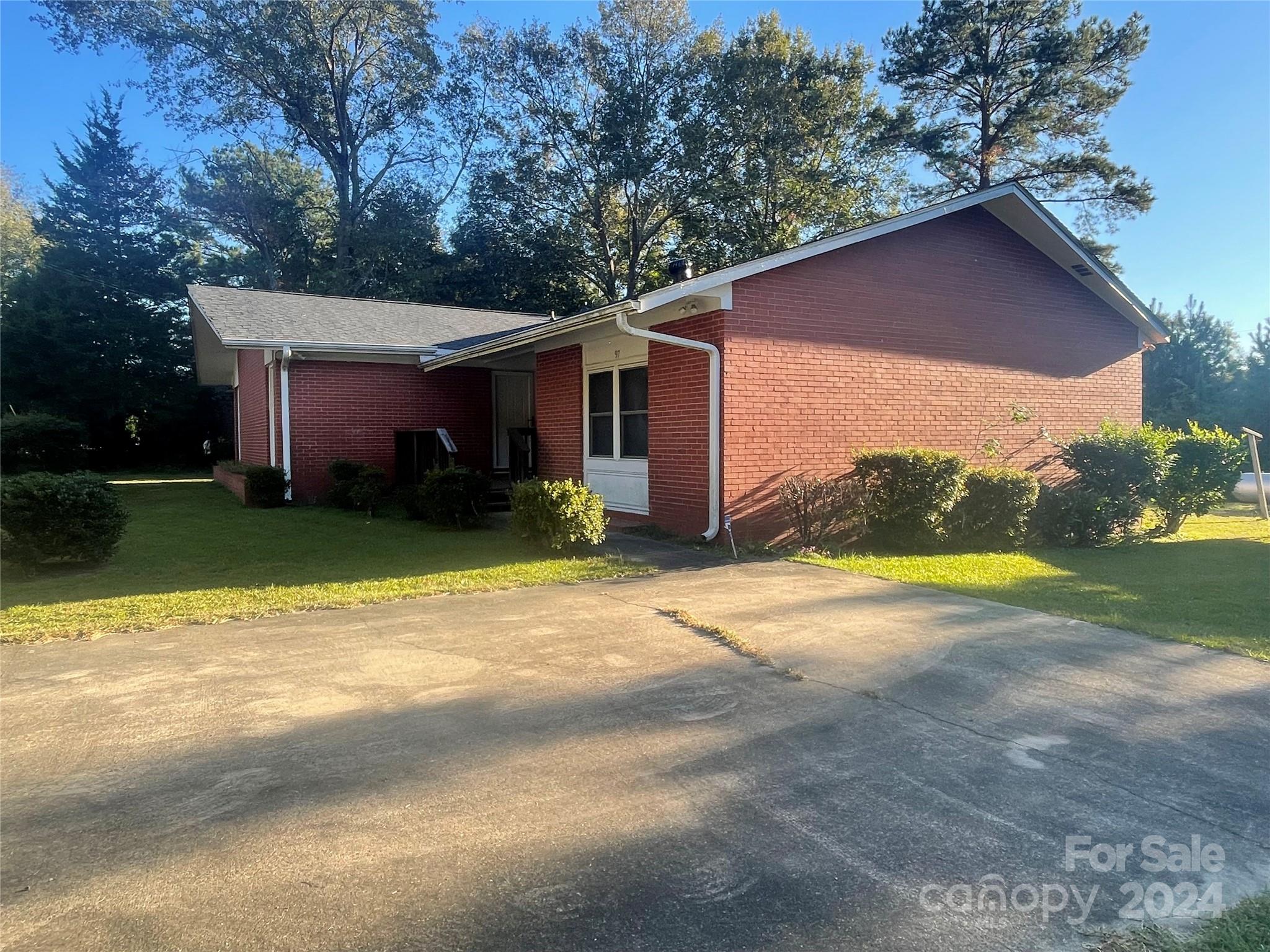 a view of a house with pool and yard