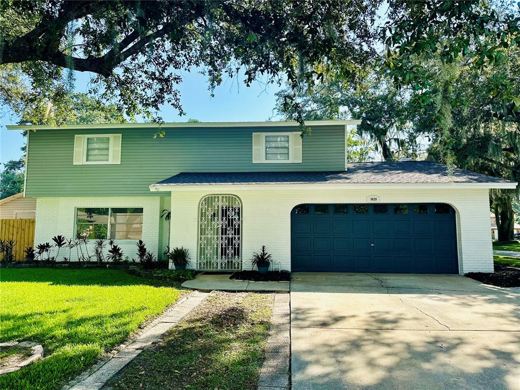 a front view of a house with a yard and garage