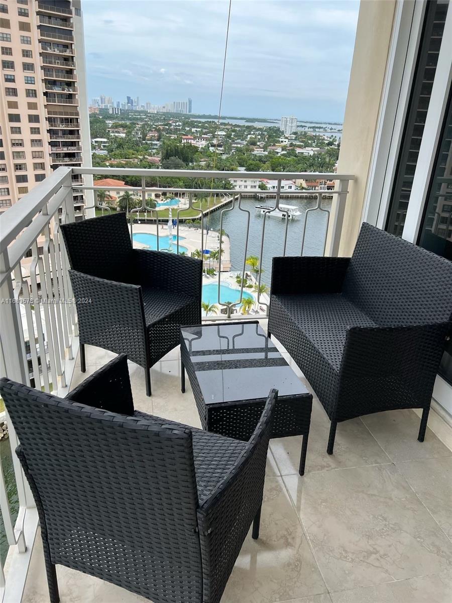 a view of a balcony with couches and wooden floor