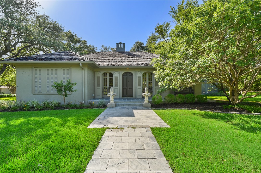 a front view of a house with garden