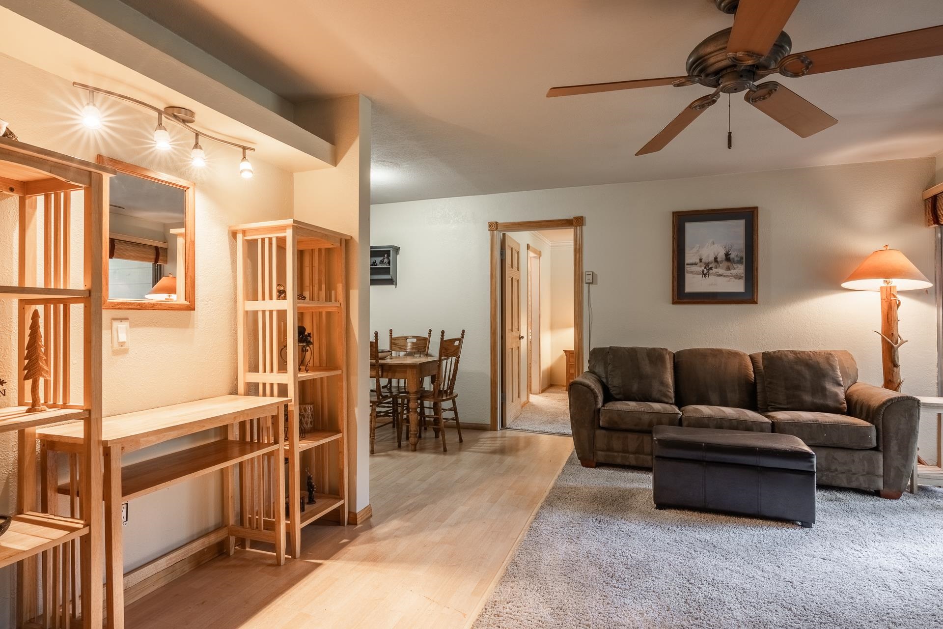 a living room with furniture and a floor to ceiling window