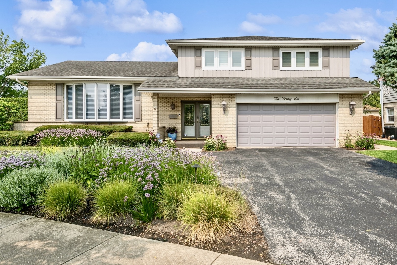 a front view of a house with a yard and garage