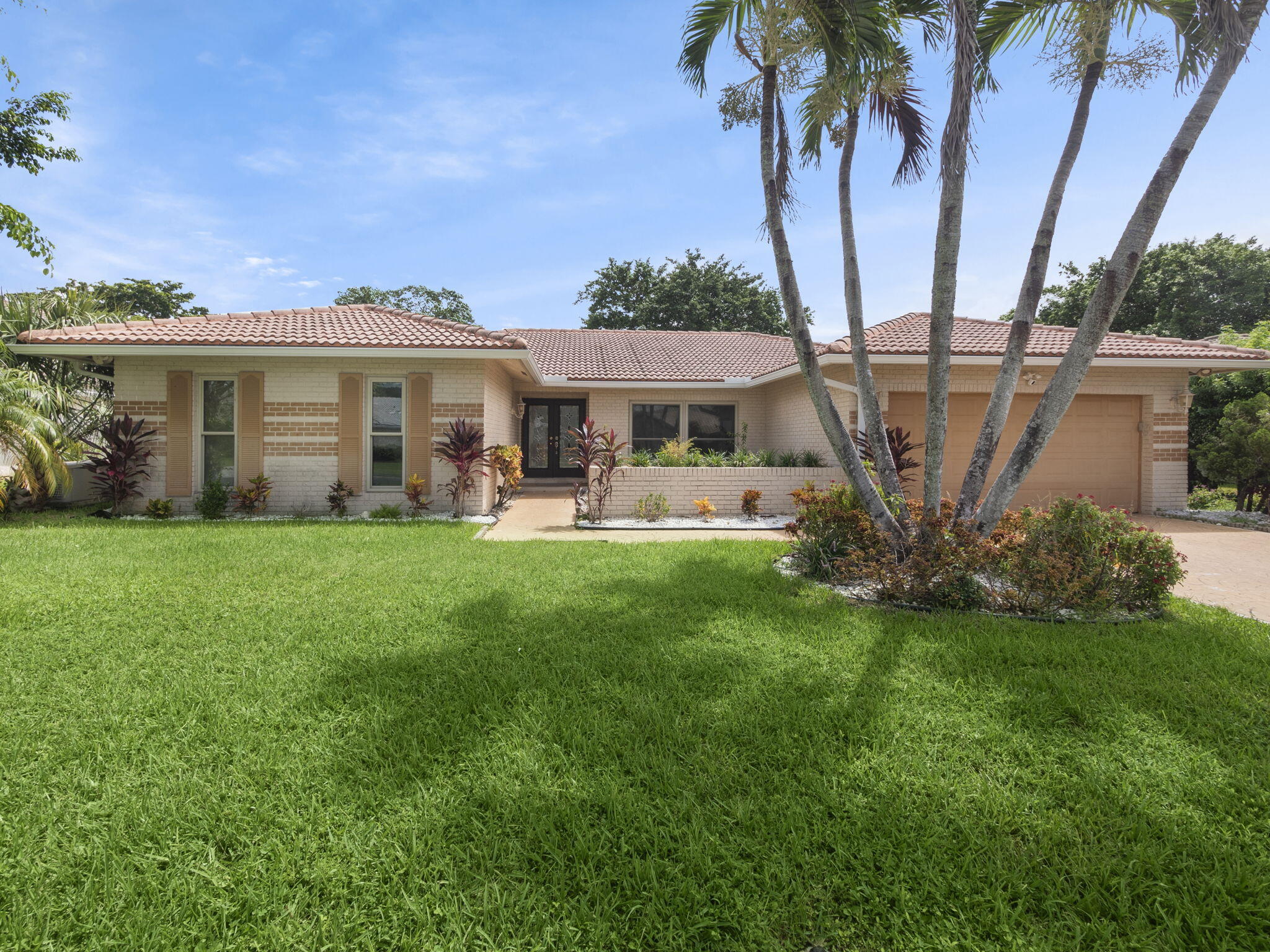 a front view of a house with garden