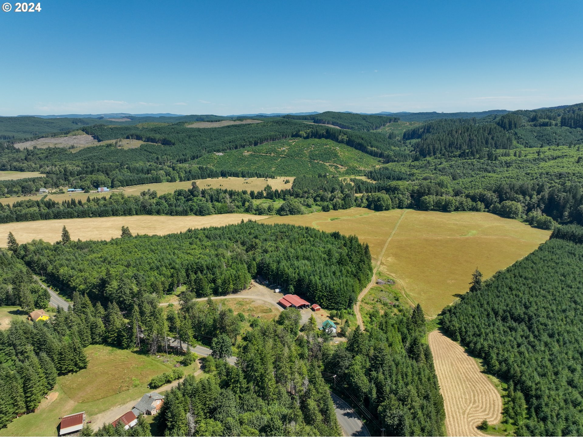 an aerial view of a houses with a yard and lake view