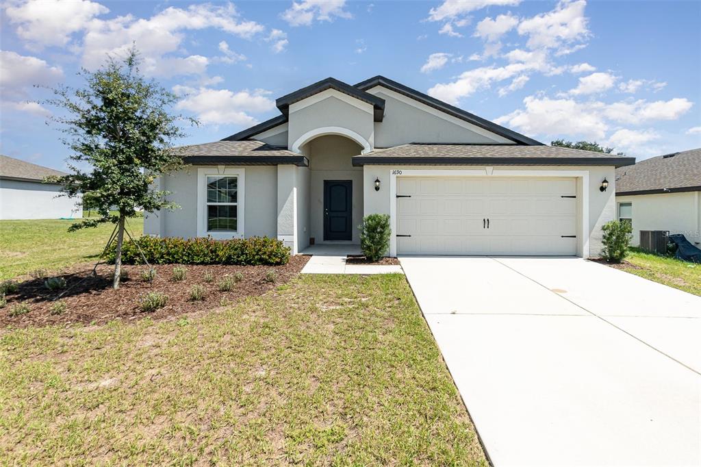 a front view of a house with a yard