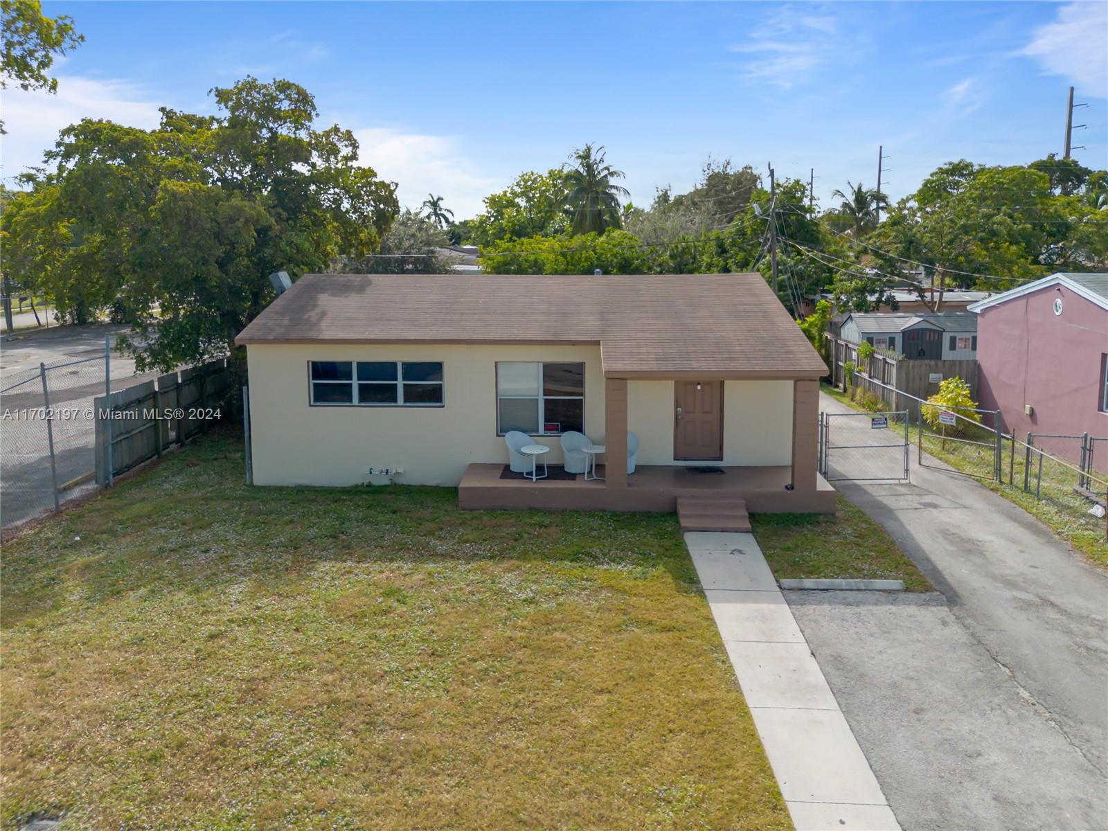 a aerial view of a house with swimming pool in front of it