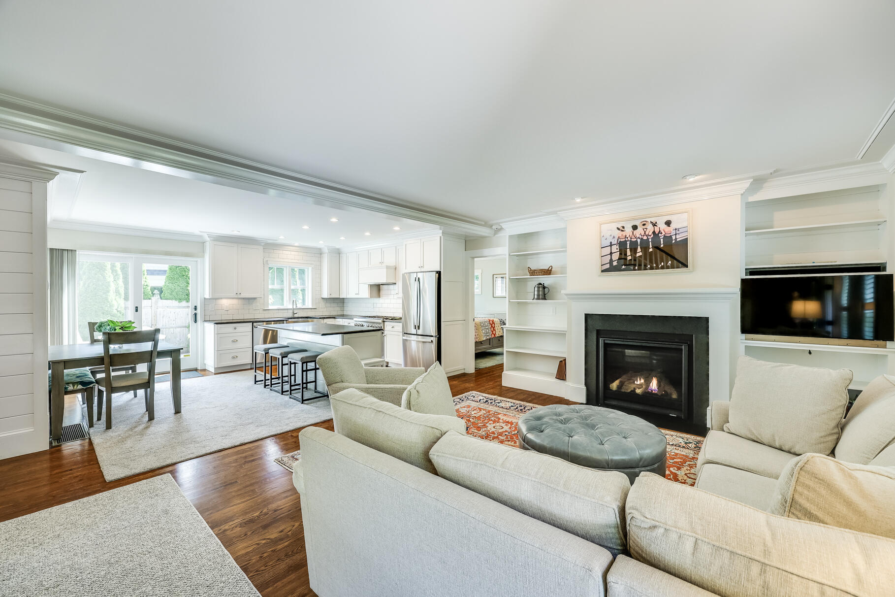 a living room with furniture a flat screen tv and a fireplace