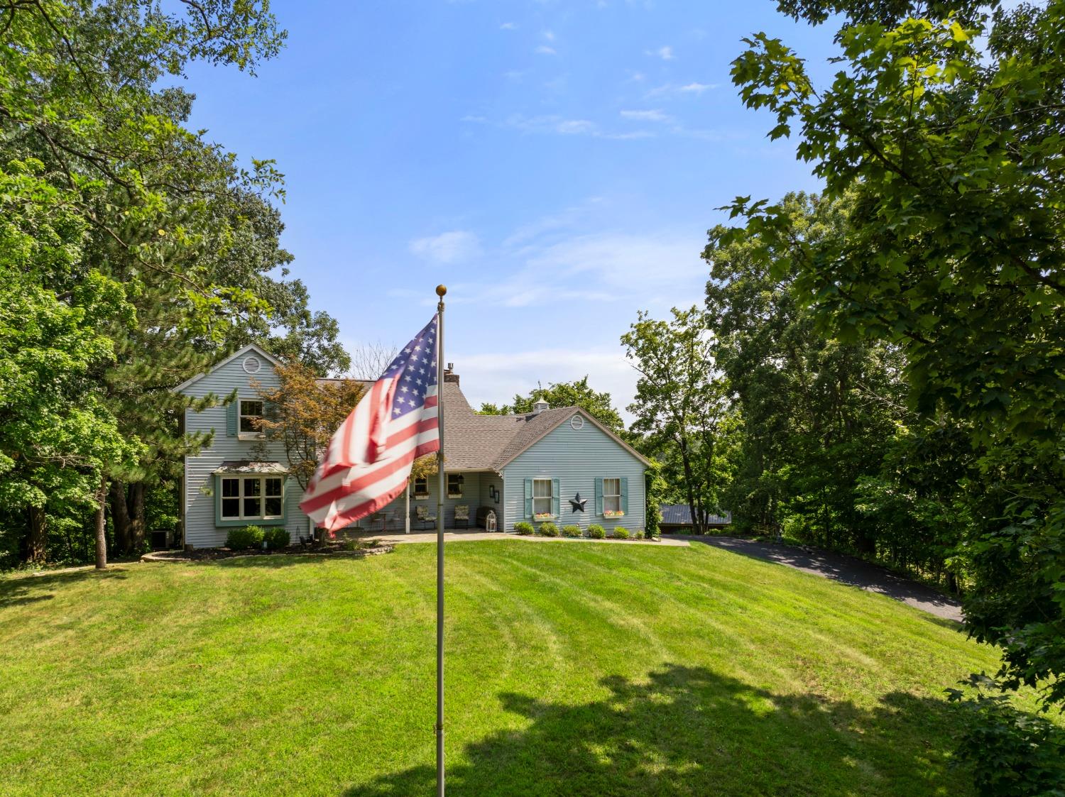 Two story transitional home set up from the road.