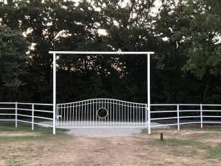 a view of a yard with wooden fence