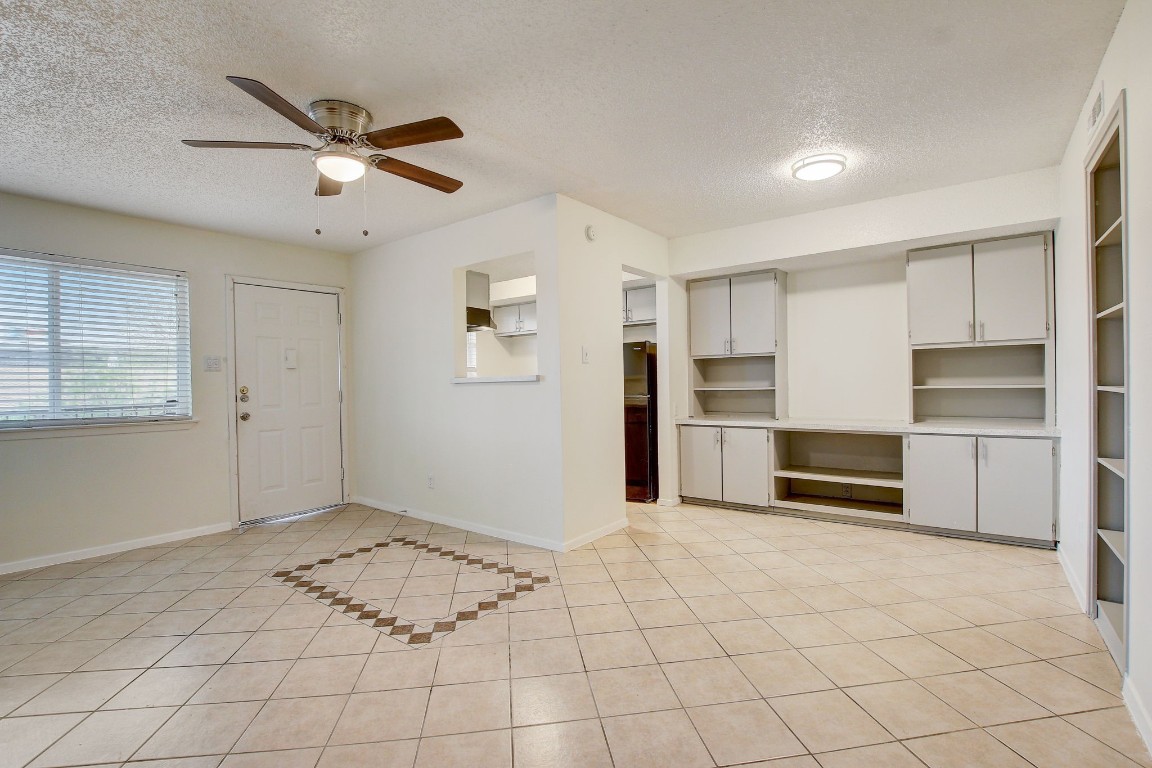 a view of a kitchen with a sink and refrigerator