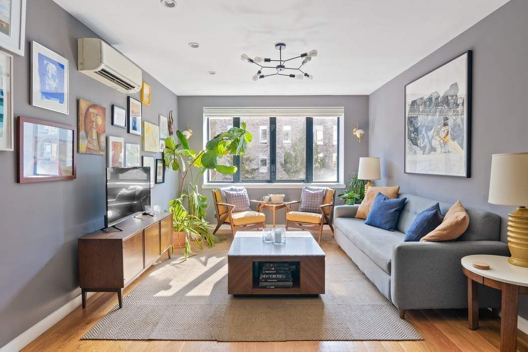 a living room with furniture and large windows