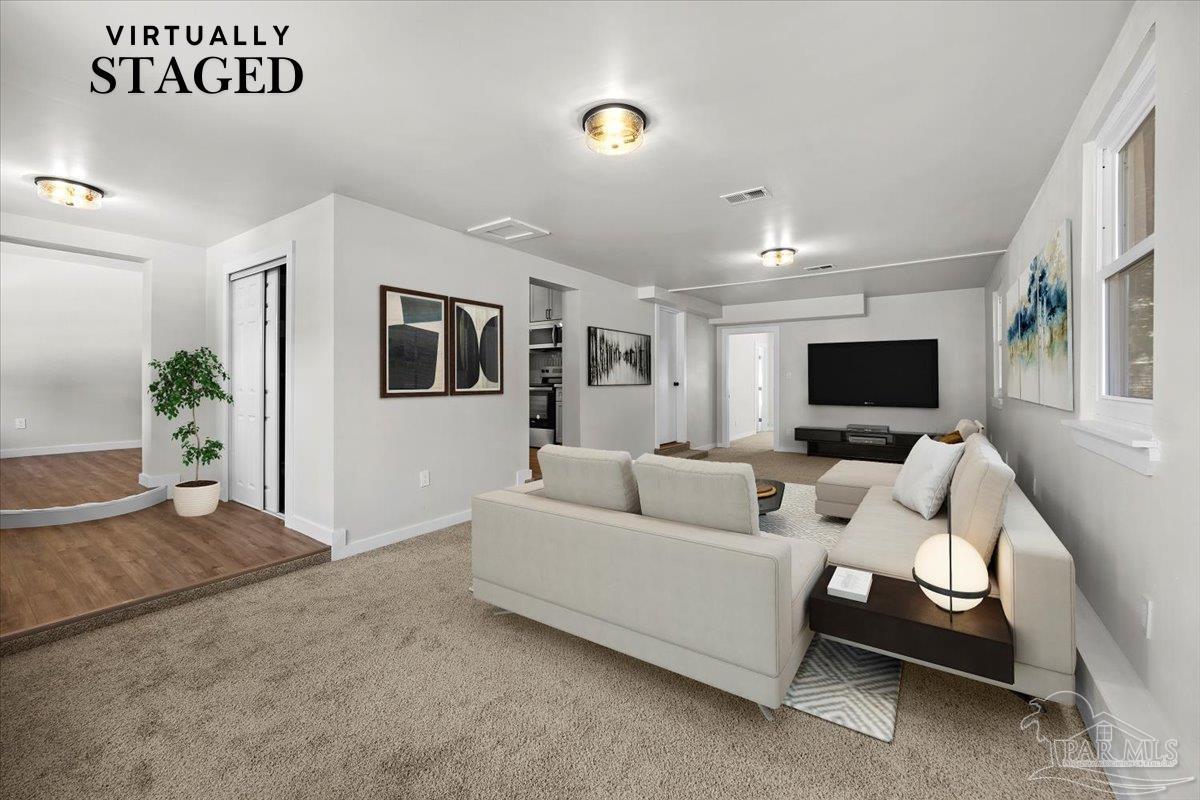 a living room with furniture and a flat screen tv