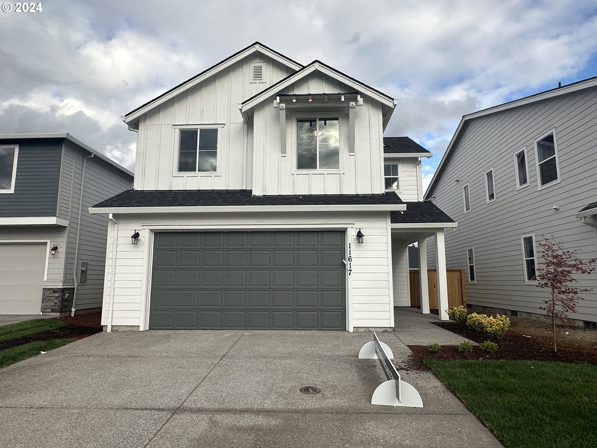 a front view of a house with a yard and garage