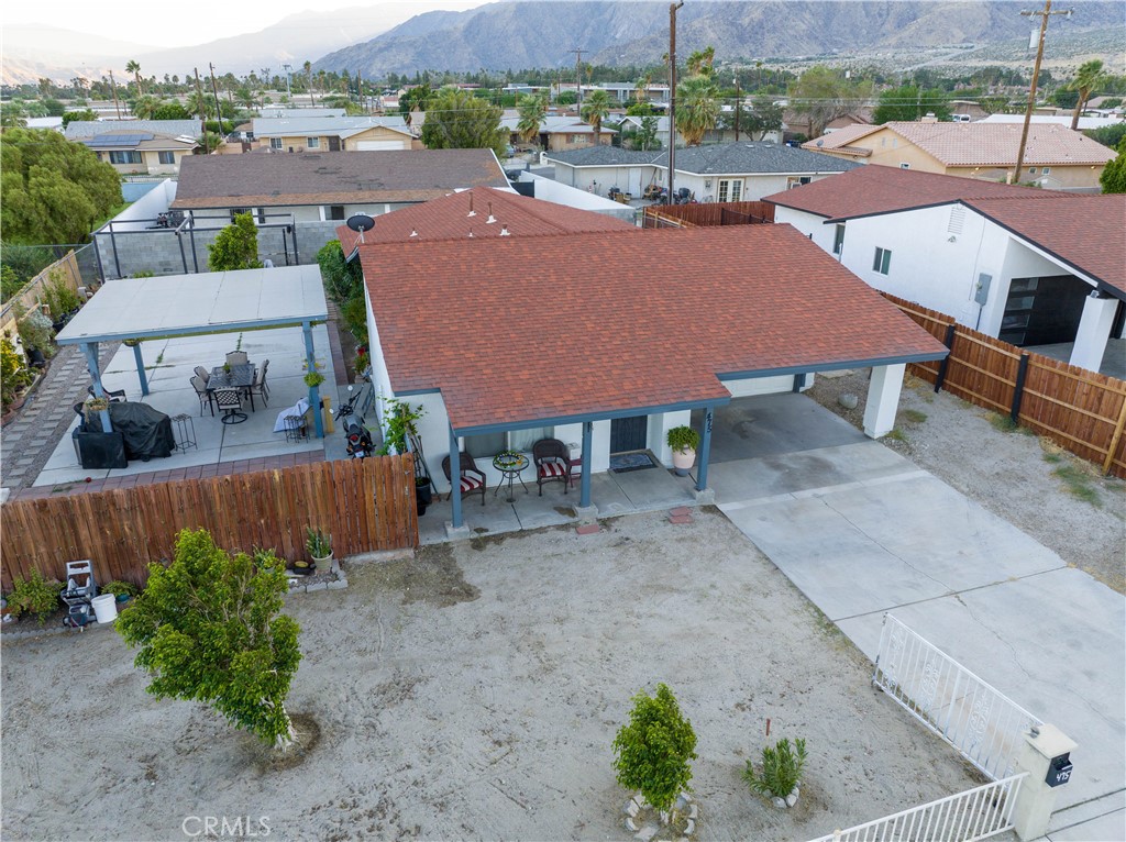 an aerial view of a house with garden space and street view