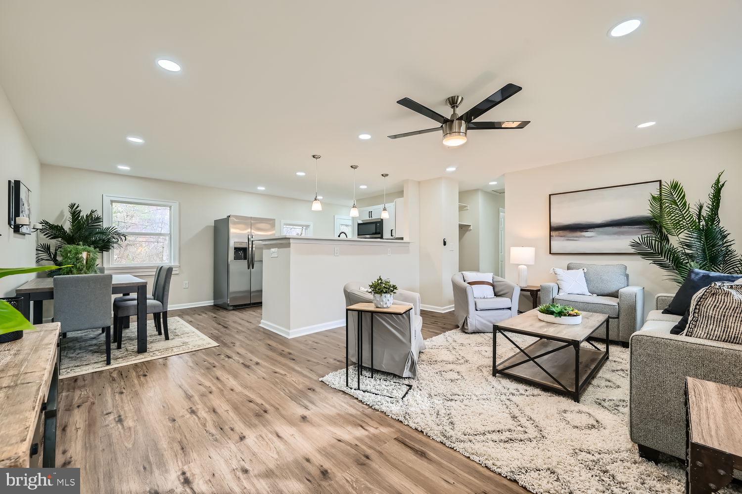 a living room with furniture and kitchen view